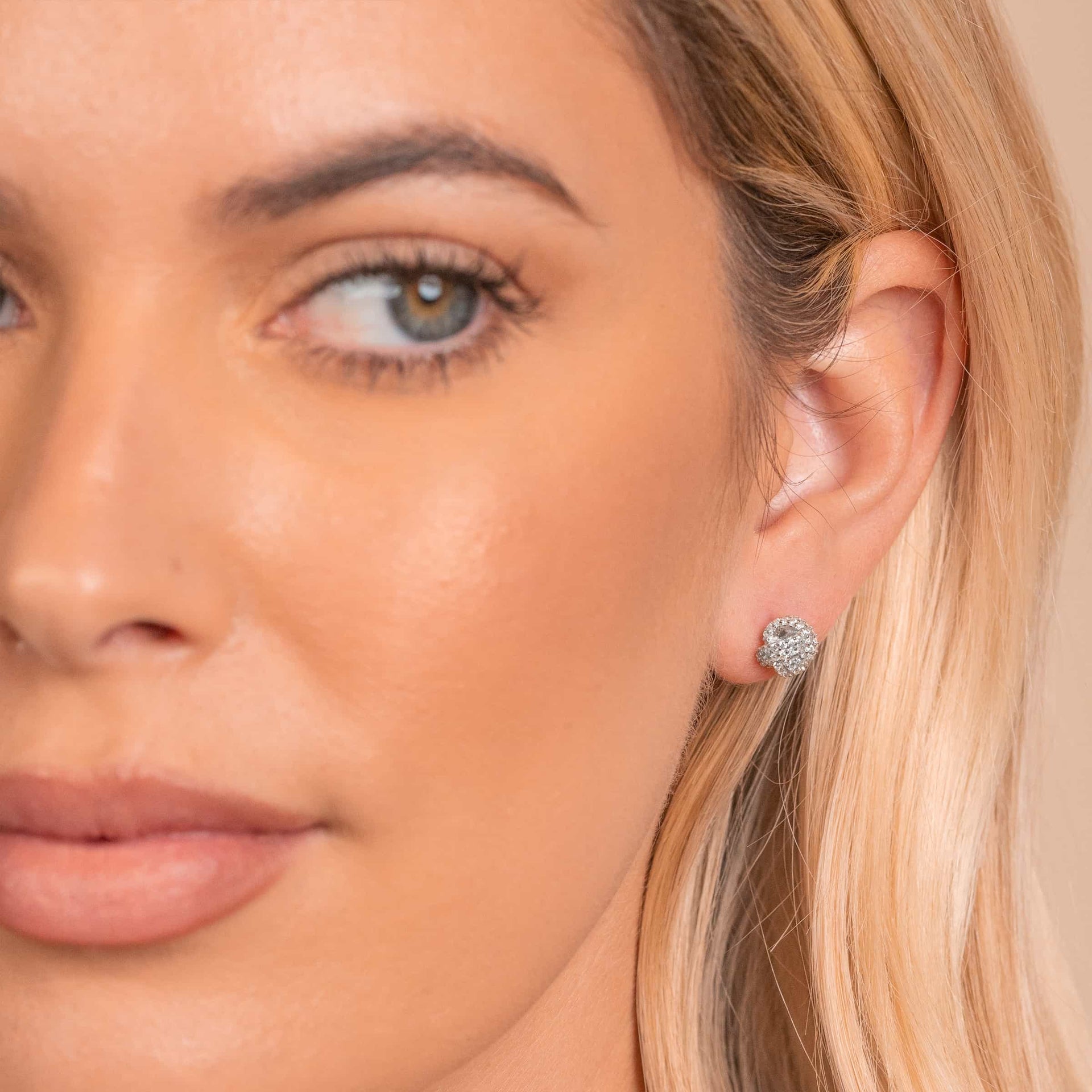 Dainty silver bridal earrings on model