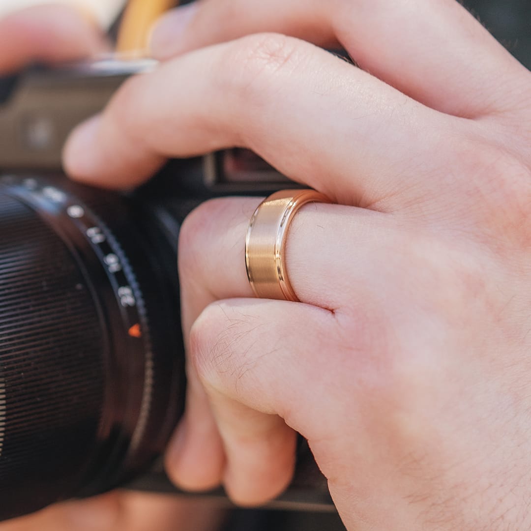 rose gold tungsten wedding ring on a hand