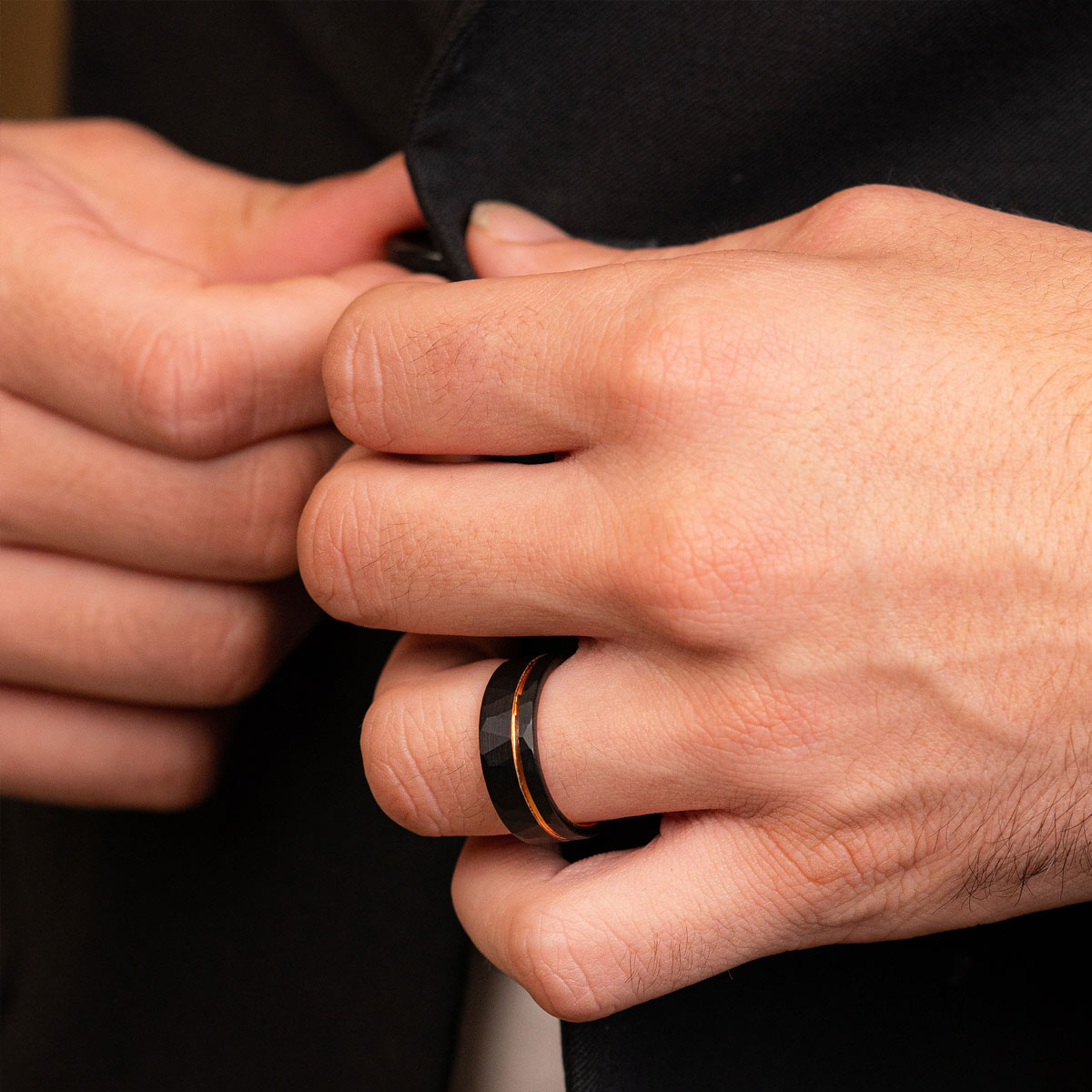 Sleek black and rose gold mens ring on hand