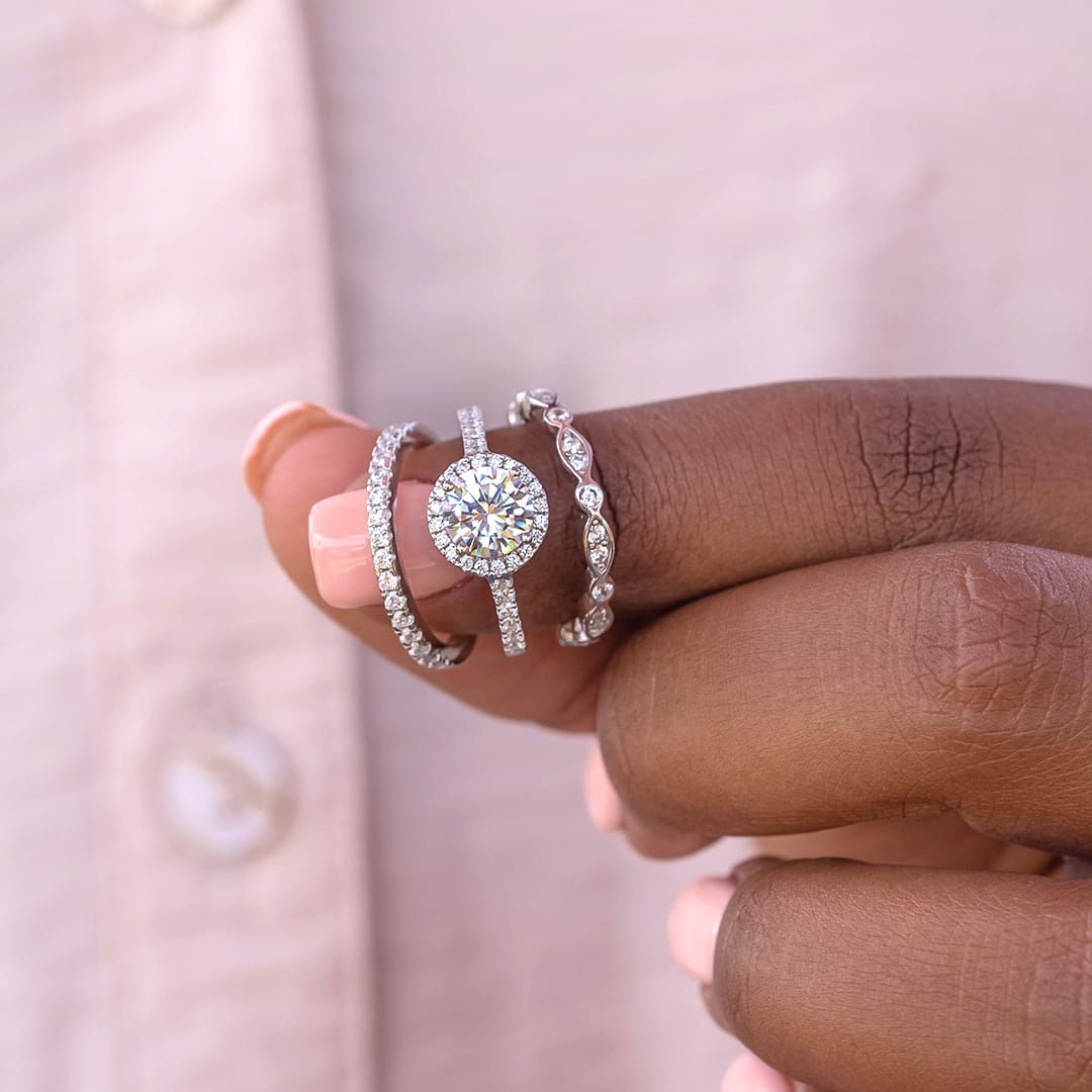 affordable wedding rings held by fingers