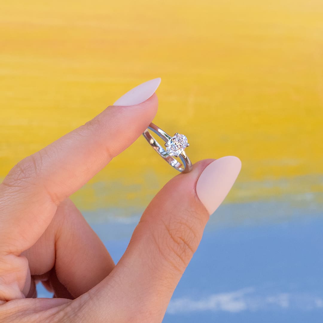 girls holding petite engagement ring