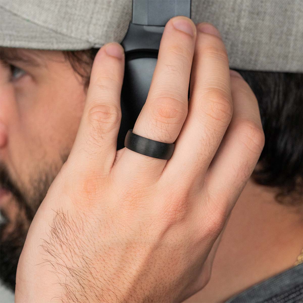 Trendy black mens wedding ring on model