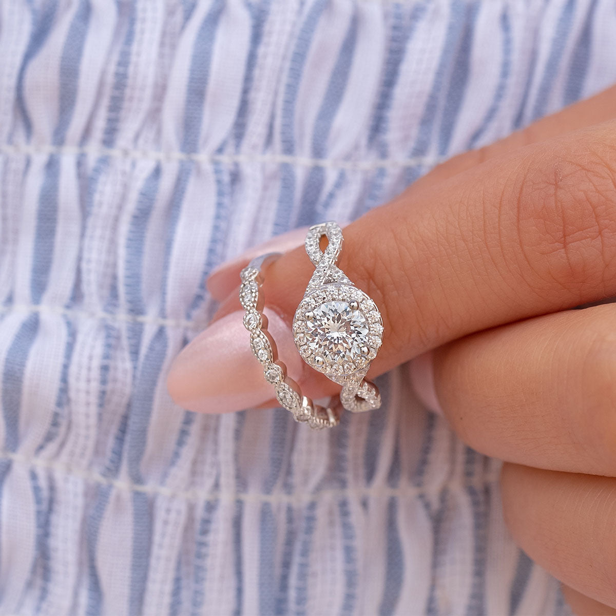 Vintage round cut silver engagement ring on finger