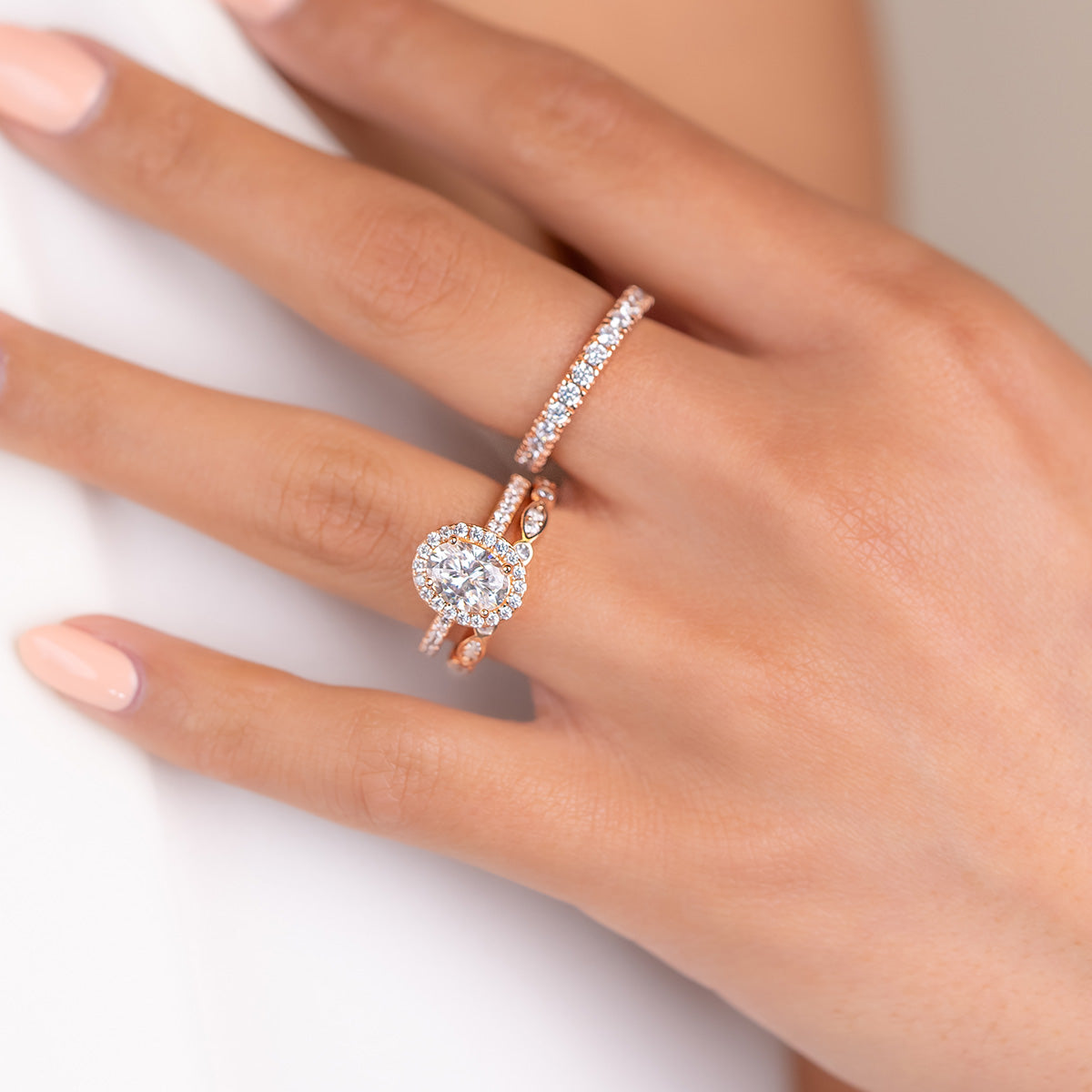 Rose gold oval engagement ring with wedding bands