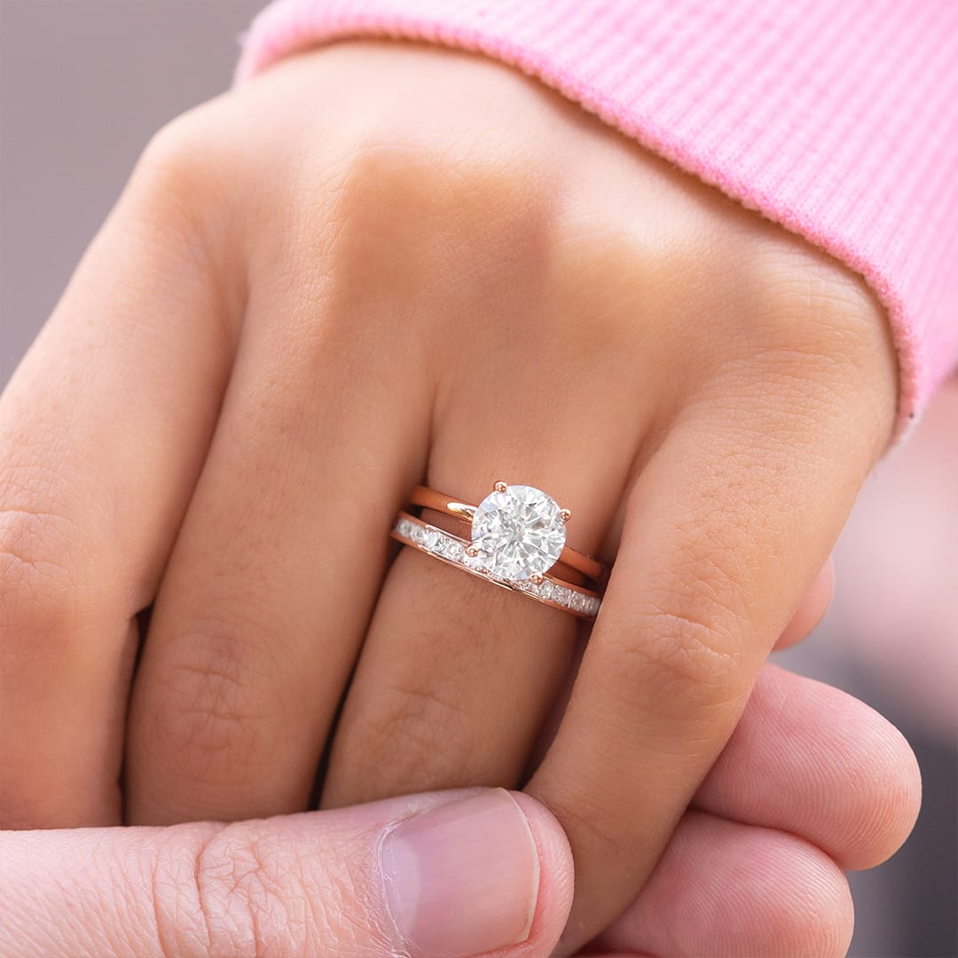 guy holding hand wearing wedding rings