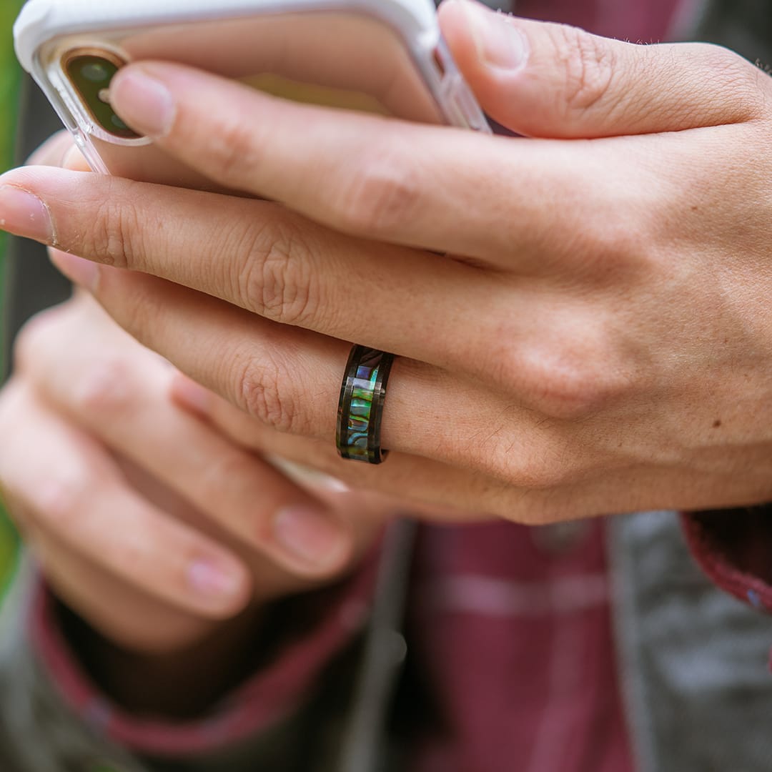 guy wearing the voyager black tungsten wedding ring with abalone inlay