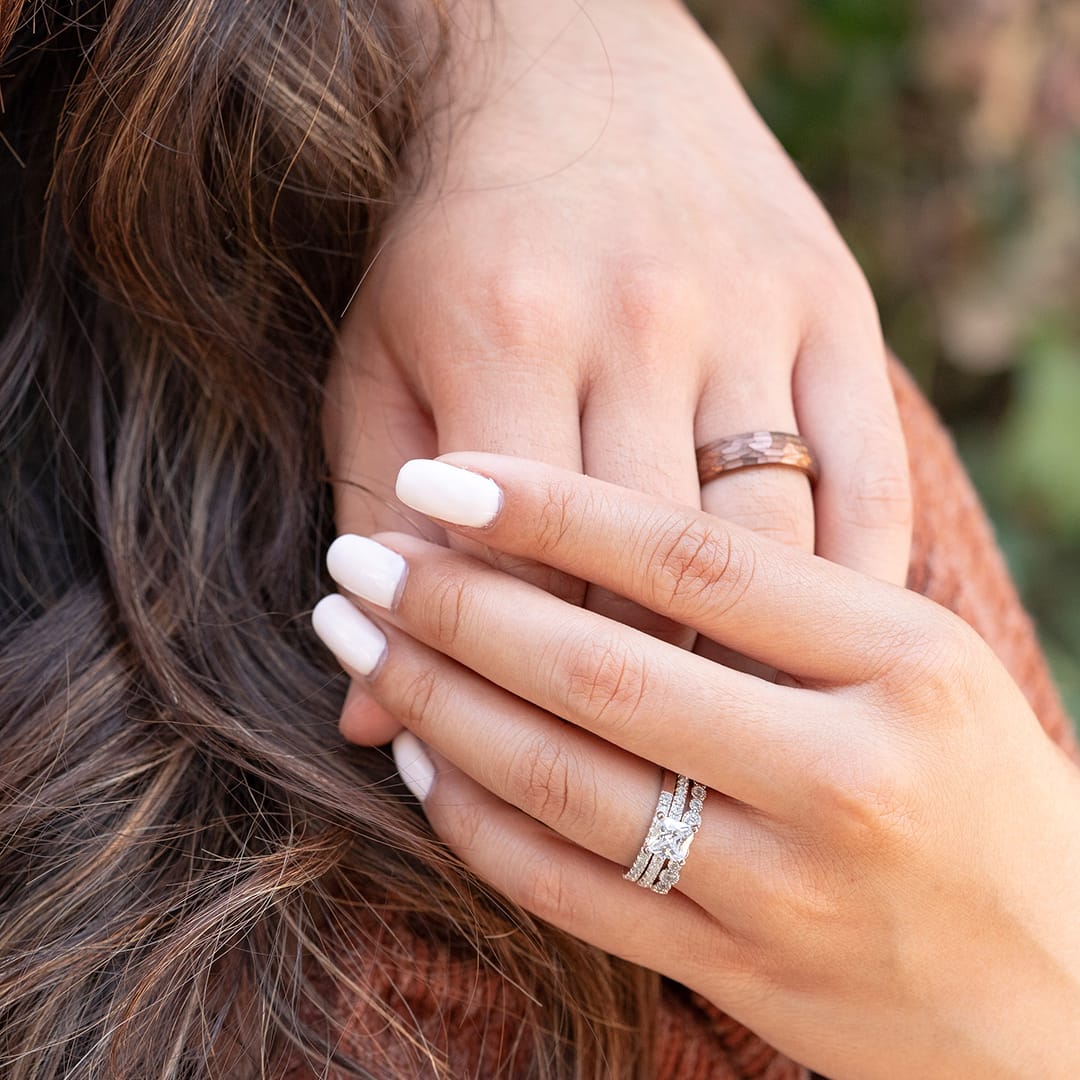 couple holding hands wearing rings