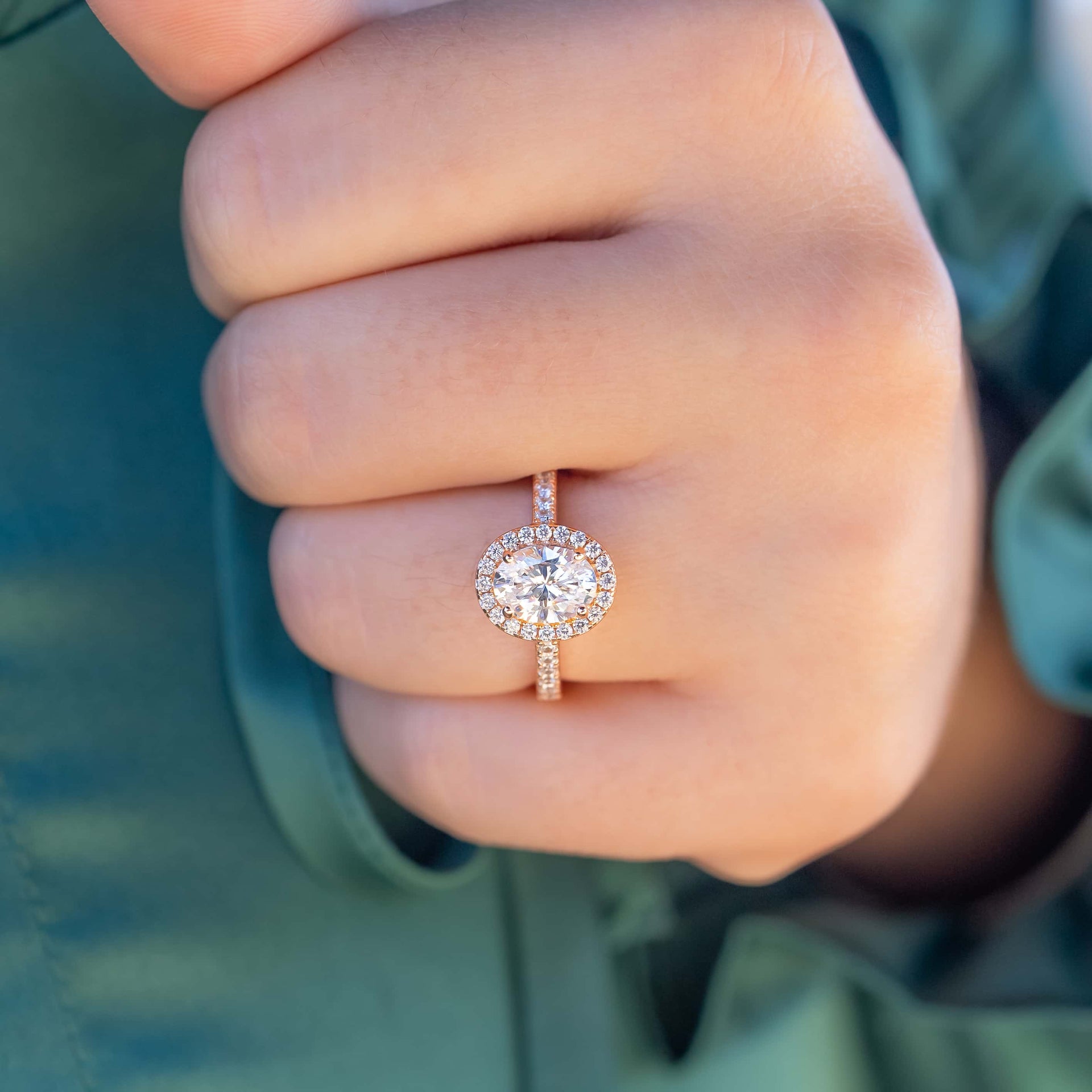 Rose gold oval engagement ring in rose gold on a female hand