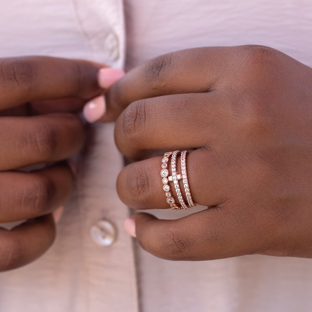 hand with rose gold wedding bands