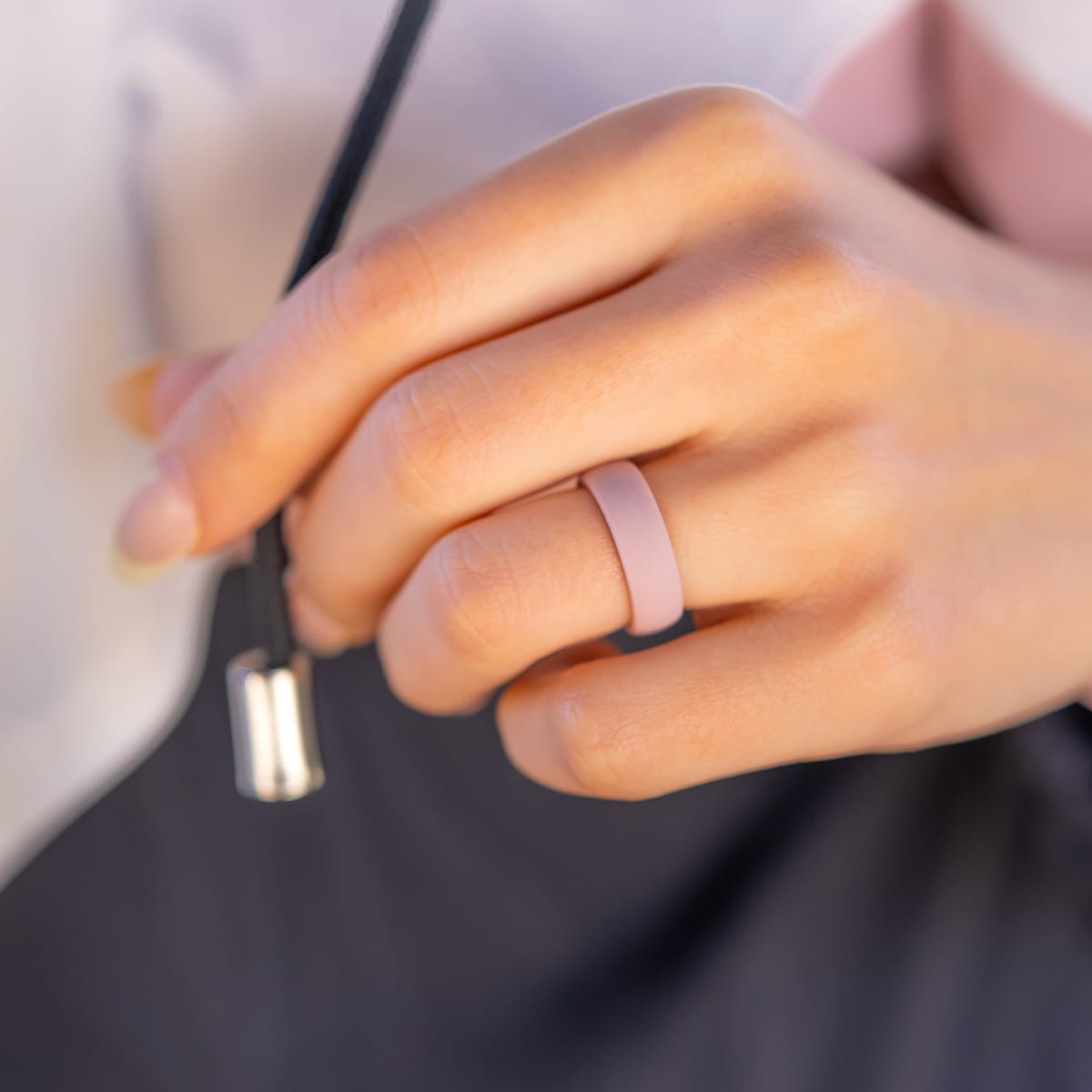 Female wearing a unique pink silicone rings