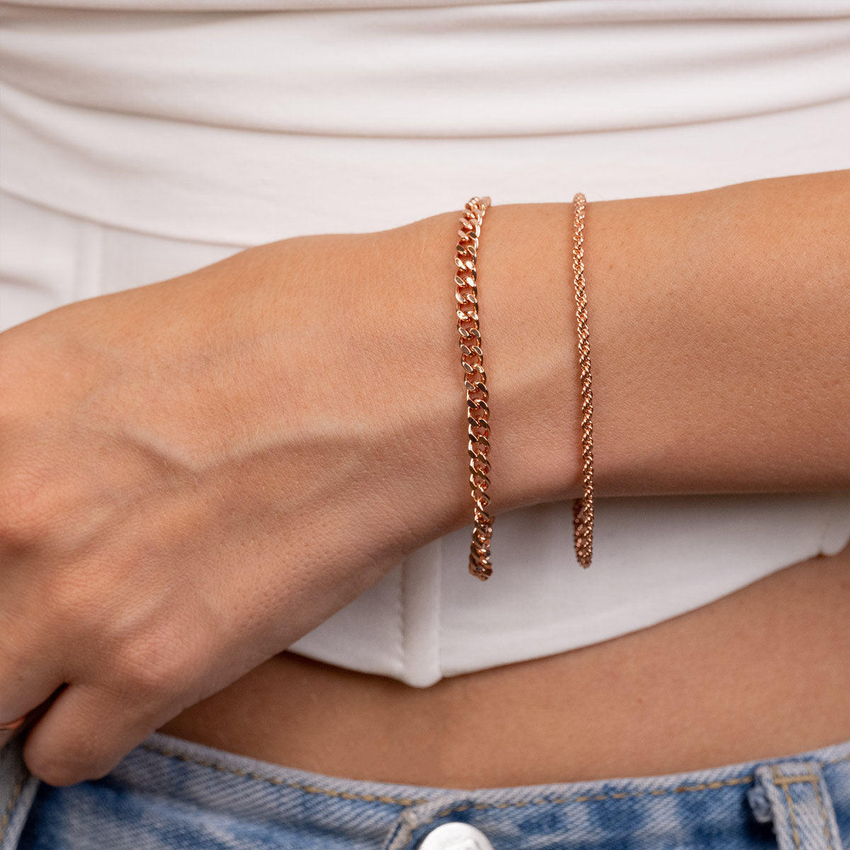 Layered rose gold rope bracelet on model