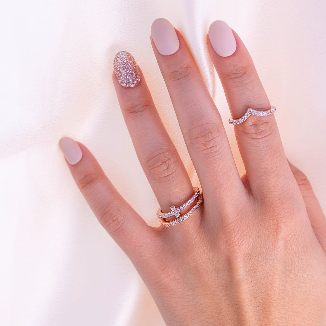 ladies hand wearing rose gold wedding rings