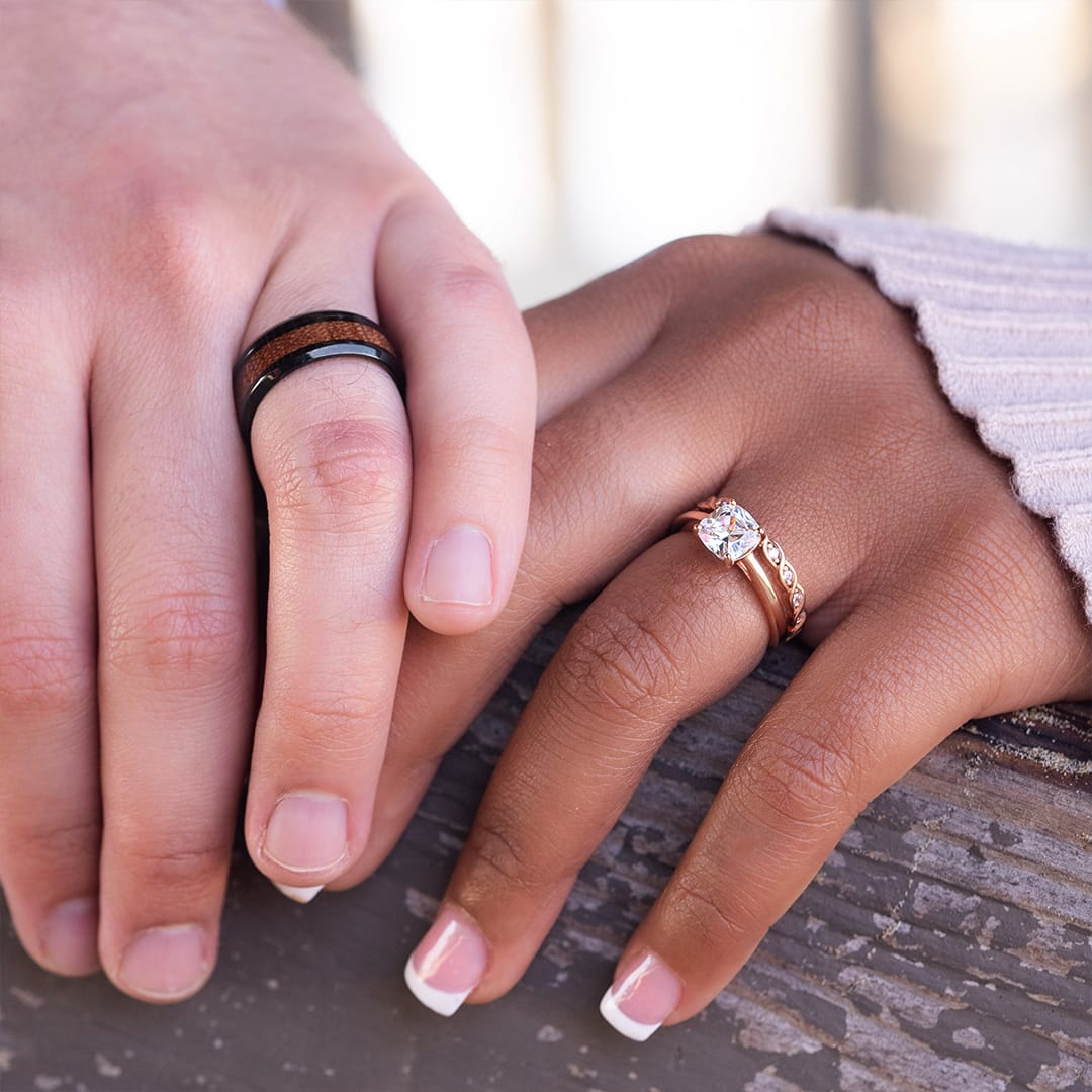 holding hands wearing wedding rings